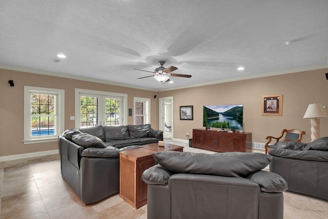 living room featuring light tile patterned flooring, ceiling fan, ornamental molding, and a textured ceiling