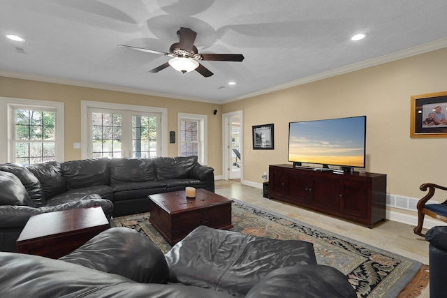 living room with crown molding, ceiling fan, and light tile patterned floors