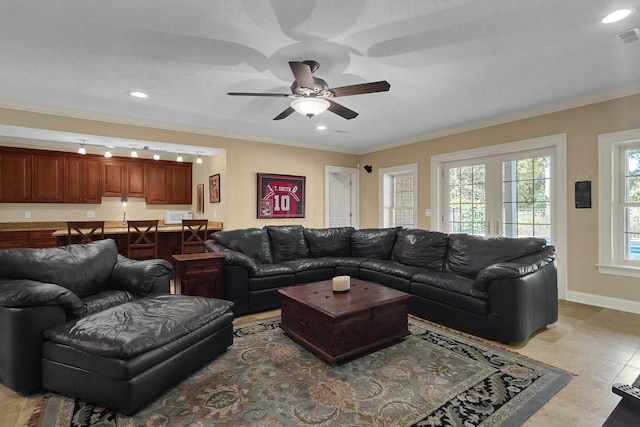 tiled living room featuring crown molding and ceiling fan