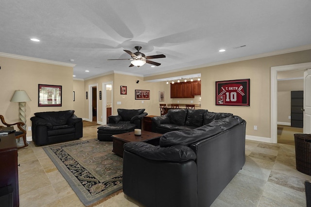 living room with ceiling fan and ornamental molding