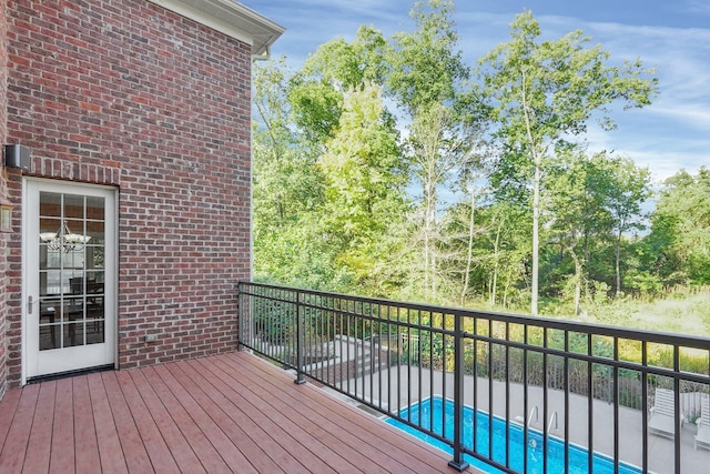 wooden terrace with a fenced in pool