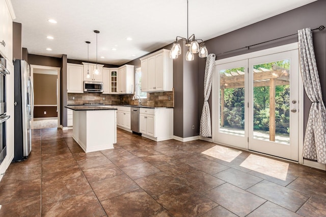 7873 Tullymore Dr, Dublin, OH 43016 - kitchen with pendant lighting, stainless steel appliances, a kitchen island, and white cabinets