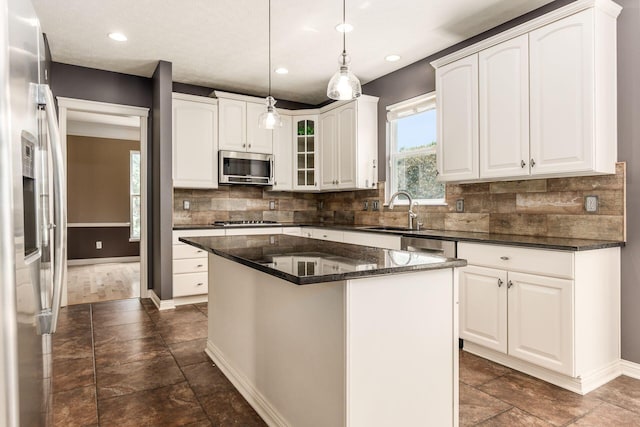 7873 Tullymore Dr, Dublin, OH 43016 - kitchen featuring white cabinetry, sink, stainless steel appliances, and a center island