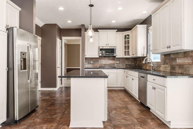 7873 Tullymore Dr, Dublin, OH 43016 - kitchen featuring a kitchen island, sink, white cabinets, hanging light fixtures, and stainless steel appliances
