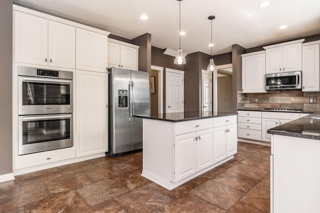 7873 Tullymore Dr, Dublin, OH 43016 - kitchen with a kitchen island, pendant lighting, tasteful backsplash, white cabinetry, and stainless steel appliances