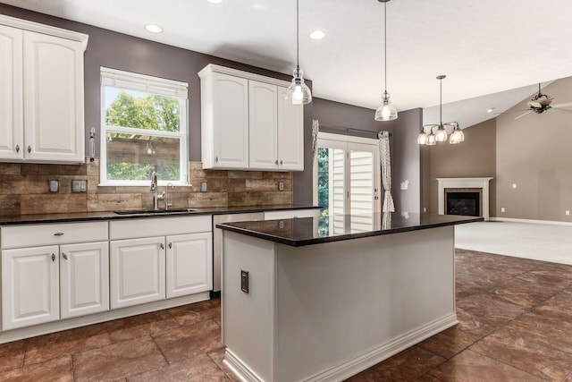 7873 Tullymore Dr, Dublin, OH 43016 - kitchen featuring sink, white cabinetry, tasteful backsplash, decorative light fixtures, and a kitchen island