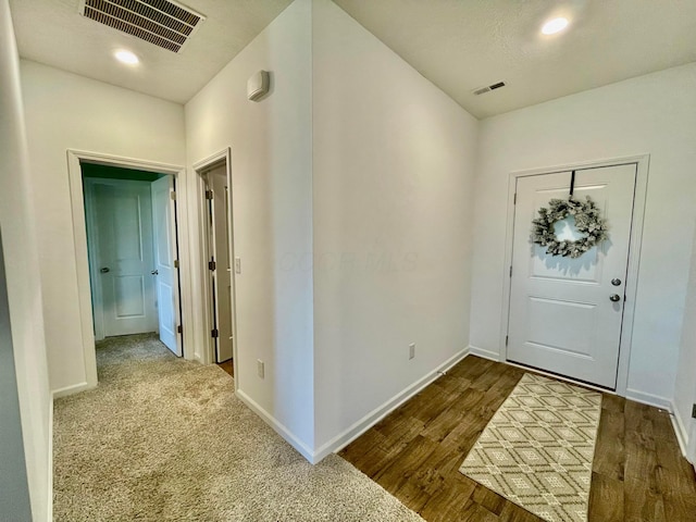 foyer entrance featuring dark wood-type flooring