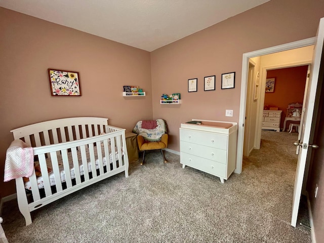 carpeted bedroom with a crib