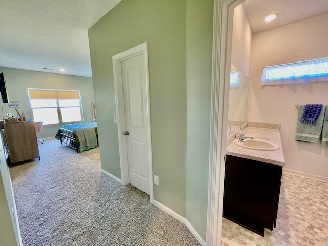 bathroom with vanity and a textured ceiling