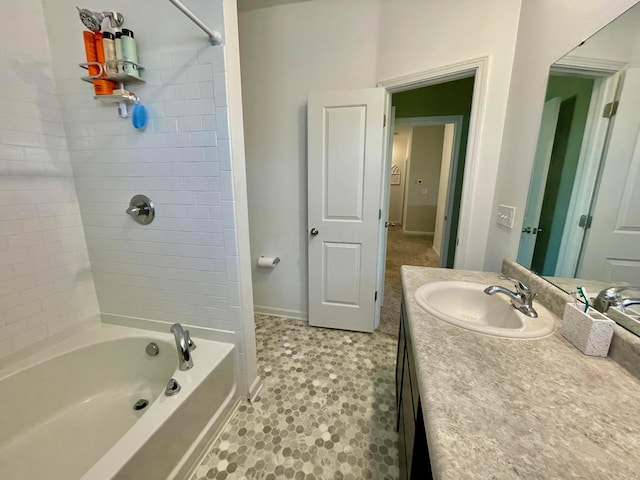 bathroom featuring tiled shower / bath combo and vanity