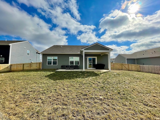 back of property with a yard and a patio area