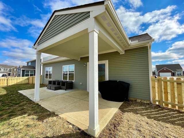 back of house featuring an outdoor living space and a patio