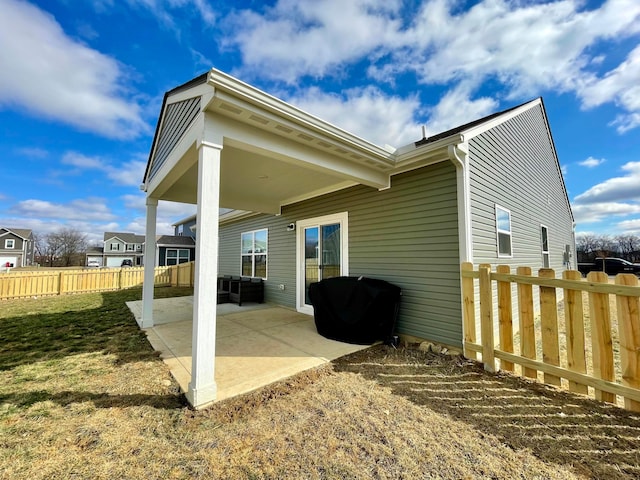 back of house featuring a patio and a yard