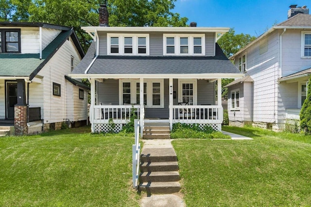 view of front of house with a front yard and covered porch