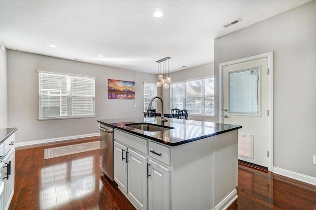 kitchen with sink, decorative light fixtures, a center island with sink, stainless steel dishwasher, and white cabinets