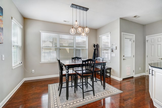 dining area with a wealth of natural light and dark hardwood / wood-style floors