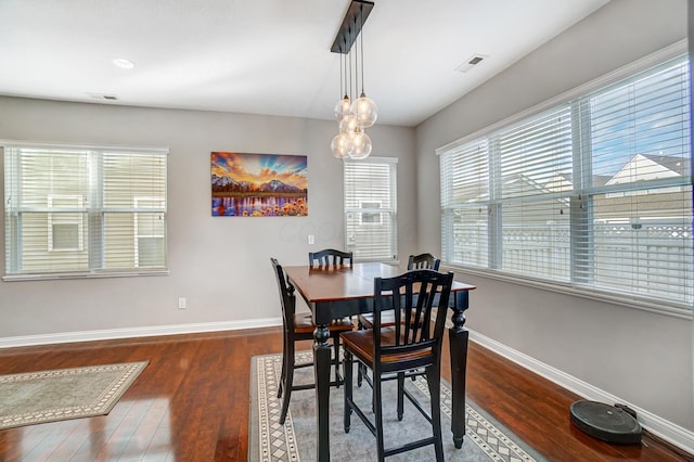 dining room with dark wood-type flooring