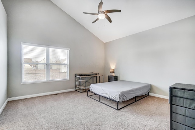 bedroom with ceiling fan, high vaulted ceiling, and carpet floors