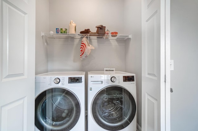 washroom featuring washer and clothes dryer