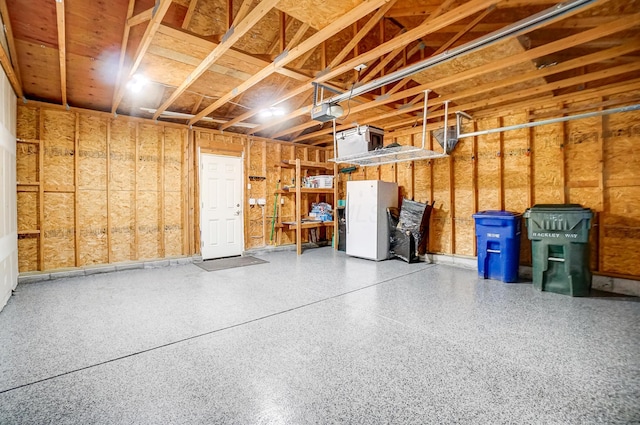 garage with a garage door opener and white fridge