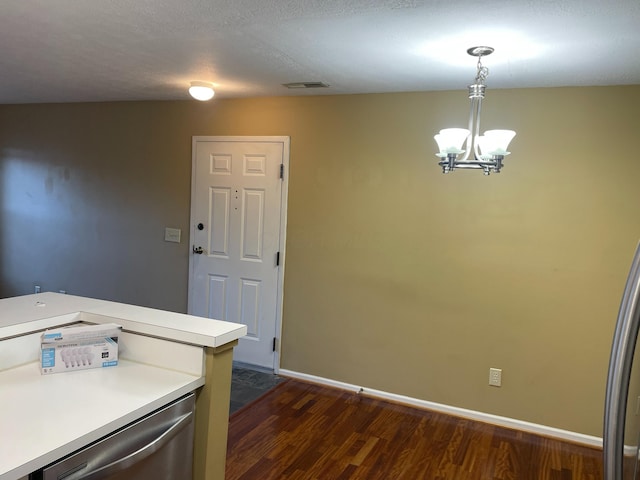 kitchen with dark hardwood / wood-style flooring, decorative light fixtures, dishwasher, and a chandelier