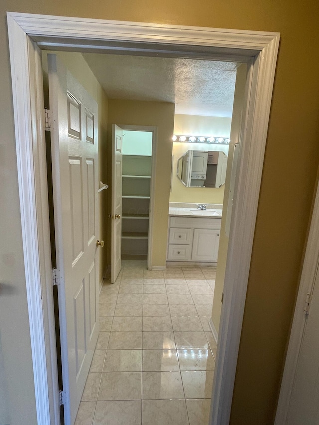 bathroom featuring vanity, tile patterned floors, and a textured ceiling