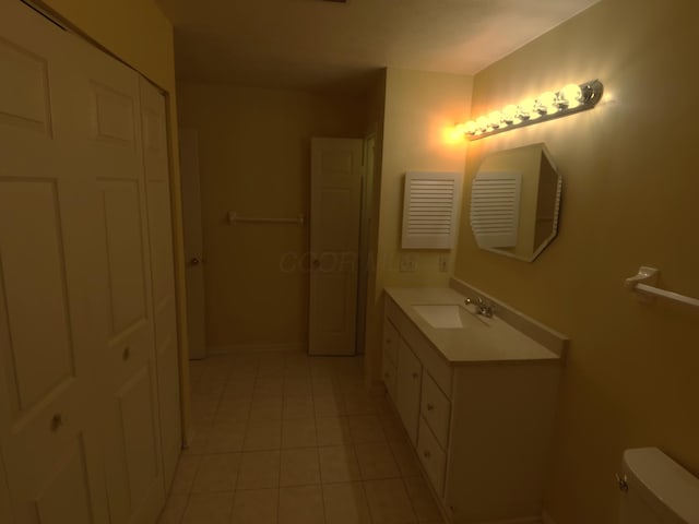 bathroom featuring vanity, toilet, and tile patterned flooring