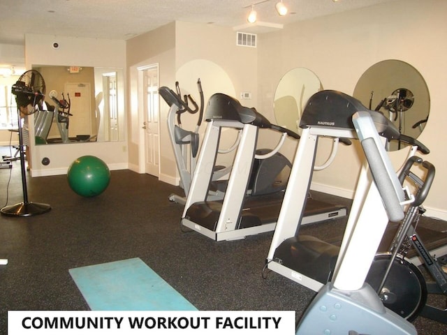 workout area featuring a textured ceiling