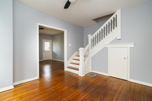 stairs with hardwood / wood-style flooring and ceiling fan