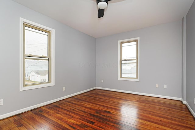 empty room featuring dark hardwood / wood-style flooring and ceiling fan