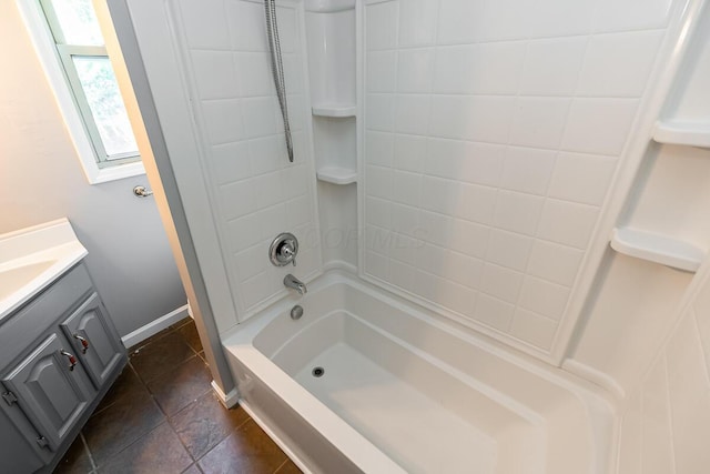 bathroom with tiled shower / bath combo and vanity