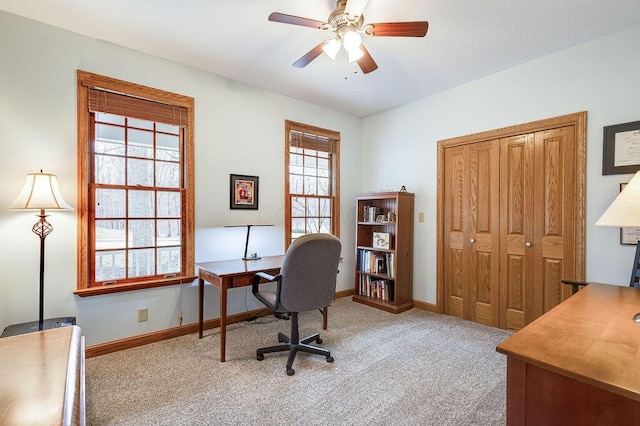 carpeted office featuring ceiling fan