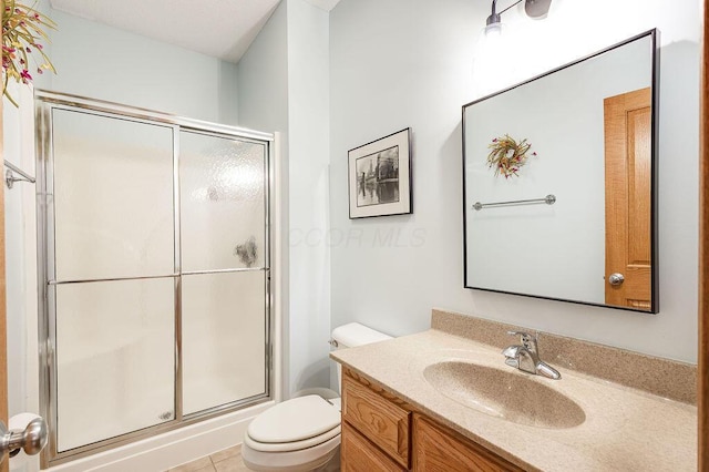 bathroom with walk in shower, vanity, and toilet