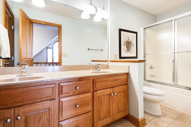 full bathroom with tile patterned floors, toilet, bath / shower combo with glass door, a chandelier, and vanity