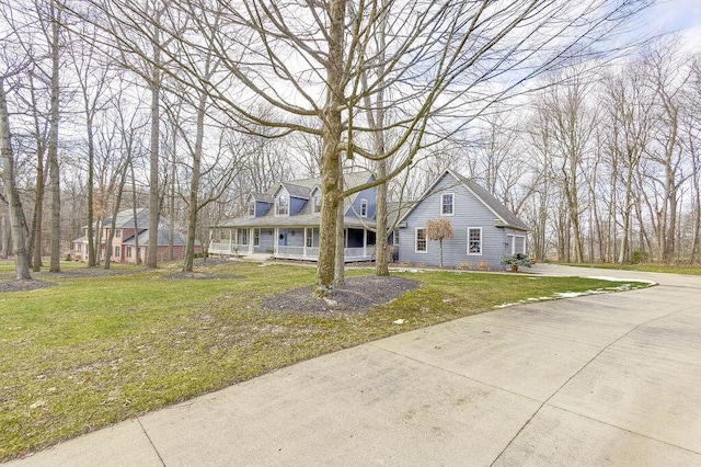 view of front of home with covered porch and a front lawn