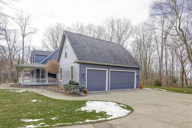 view of property exterior featuring a porch, a garage, and a lawn