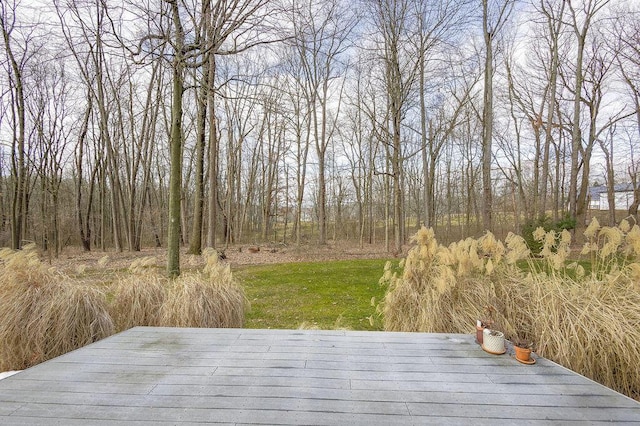 wooden deck featuring a yard