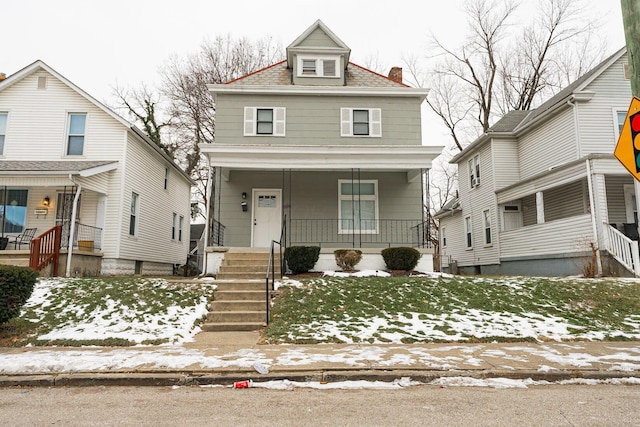 view of property with a lawn and a porch