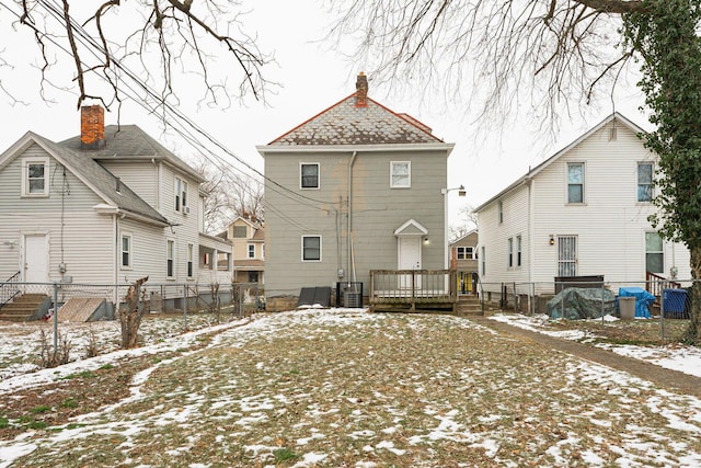 snow covered house with central air condition unit