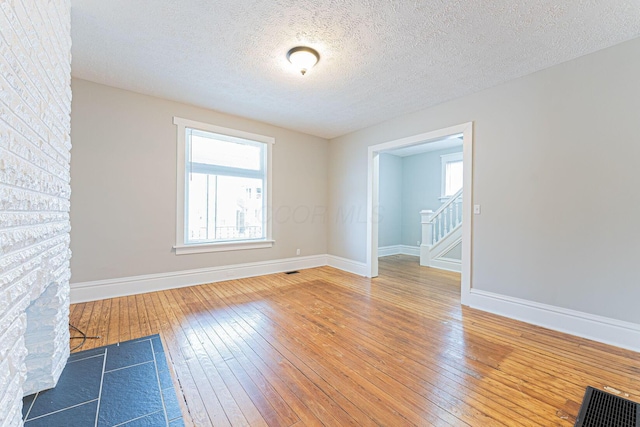 empty room featuring hardwood / wood-style flooring and a textured ceiling