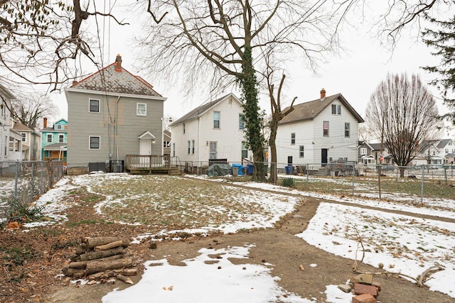 snow covered rear of property with cooling unit