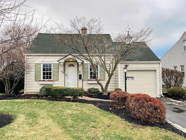 view of front of property with a garage and a front yard