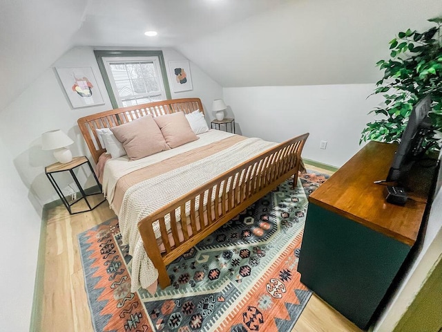 bedroom with light hardwood / wood-style flooring and vaulted ceiling