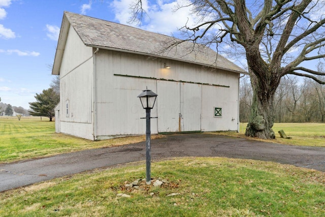 view of barn with a lawn