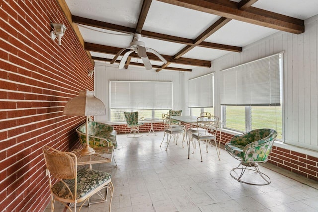 unfurnished sunroom with beamed ceiling, coffered ceiling, and ceiling fan