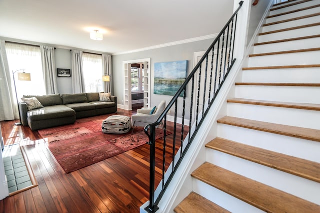 living room with hardwood / wood-style flooring and ornamental molding