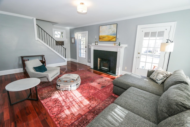 living room with hardwood / wood-style flooring, crown molding, and a healthy amount of sunlight