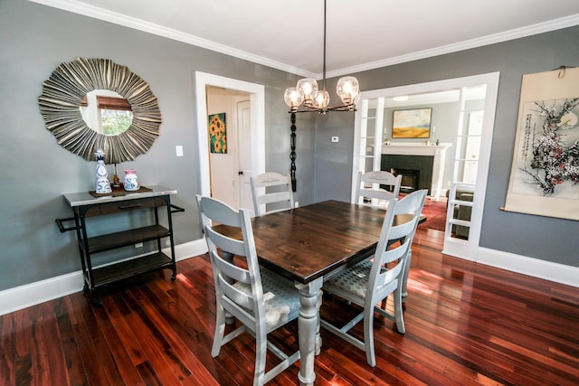 dining area with crown molding, dark hardwood / wood-style floors, and a chandelier