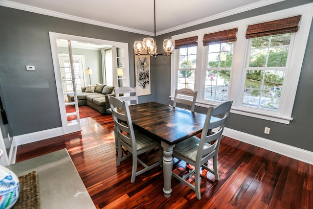 dining area featuring crown molding, dark hardwood / wood-style floors, and a chandelier