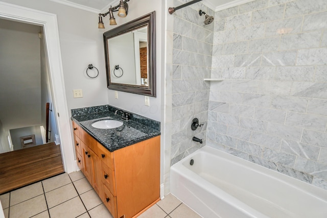 bathroom with crown molding, vanity, tiled shower / bath combo, and tile patterned flooring